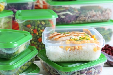 Set of plastic containers with fresh food on table