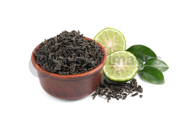 Dry bergamot tea leaves and fresh fruit on white background