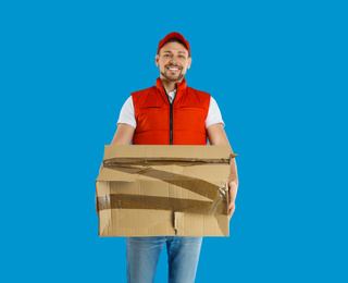 Courier with damaged cardboard box on blue background. Poor quality delivery service