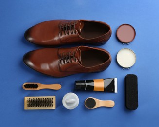 Flat lay composition with shoe care accessories and footwear on blue background
