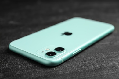 MYKOLAIV, UKRAINE - JULY 9, 2020: New modern Iphone 11 Green on black background, closeup