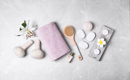 Flat lay composition with spa accessories on light background