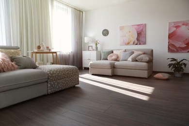 Elegant living room with comfortable sofas near windows. Interior design