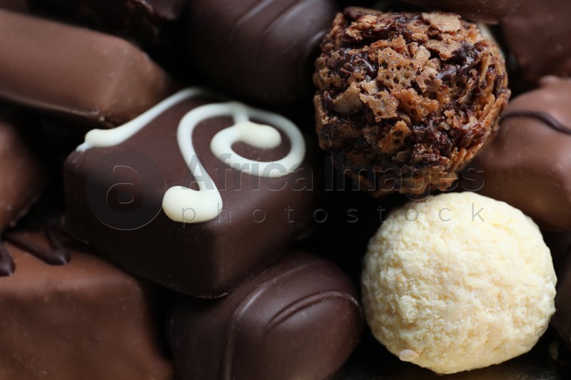 Different tasty chocolate candies as background, closeup