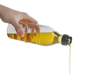 Photo of Woman pouring cooking oil from bottle on white background, closeup