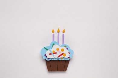 Photo of Birthday party. Paper cupcake with candles on white background, top view