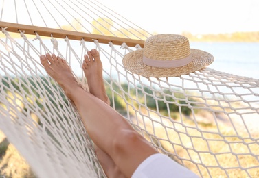 Young woman relaxing in hammock on beach, closeup. Summer vacation