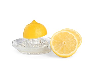 Plastic juicer and fresh lemons on white background