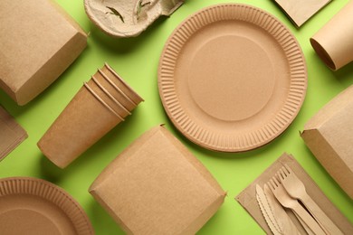 Flat lay composition with eco friendly products on light green background