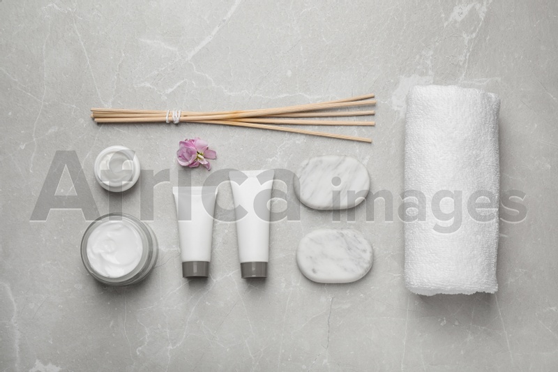 Flat lay composition with cosmetics on grey marble table. Spa treatment