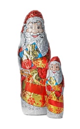 Chocolate Santa Claus figures in foil wrappers on white background