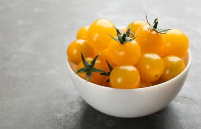 Ripe yellow tomatoes on grey table. Space for text