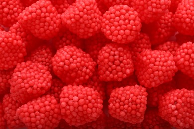 Delicious gummy raspberry candies as background, top view