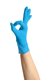 Woman in blue latex gloves showing OK gesture on white background, closeup of hand