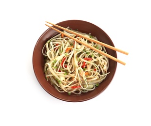 Photo of Plate of delicious noodles with broth, vegetables and chopsticks isolated on white, top view