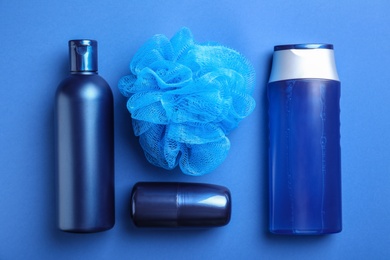 Flat lay composition with men's cosmetic products on blue background