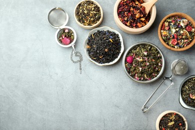 Many different herbal teas on grey table, flat lay. Space for text