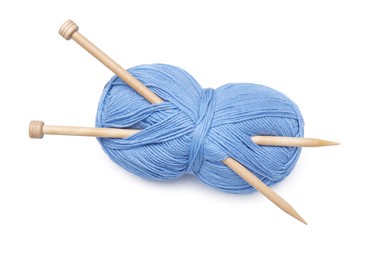 Soft light blue woolen yarn with knitting needles on white background, top view