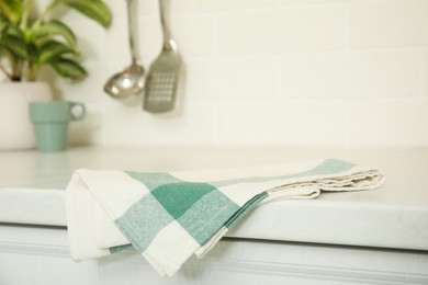 Clean towel on white countertop in kitchen