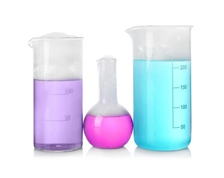 Photo of Laboratory glassware with colorful liquids isolated on white. Chemical reaction