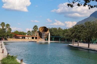 Monterrey, Mexico - September 11, 2022: Fuente de Crisol (Melting Pot Fountain) and beautiful mountains in Parque Fundidora