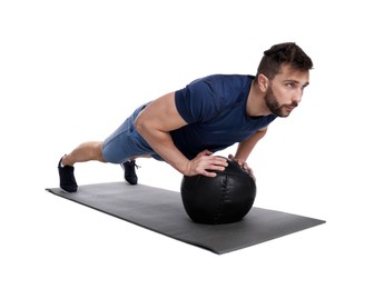 Athletic man doing exercise with medicine ball isolated on white