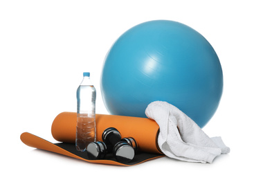 Fitness ball, bottle of water and sport accessories isolated on white