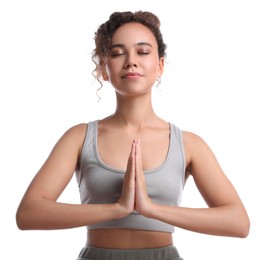 Beautiful African-American woman meditating on white background