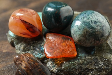 Different beautiful gemstones on table, closeup view