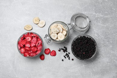 Many different freeze dried fruits on light grey table, flat lay