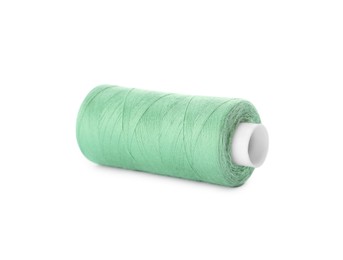 Spool of light green sewing thread isolated on white
