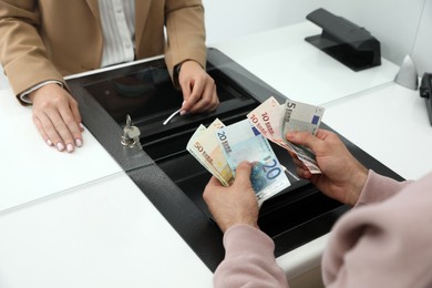 Man exchanging money in bank, closeup view