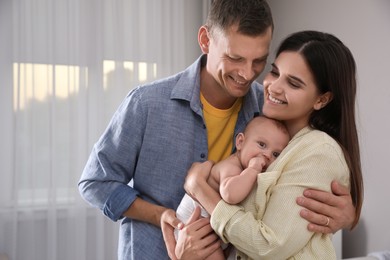 Happy family with their cute baby at home