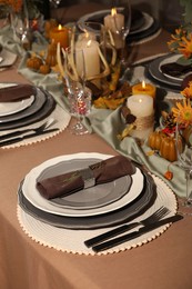 Beautiful autumn place setting and decor for festive dinner on table