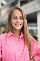 Photo of Portrait of smiling beautiful young woman outdoors