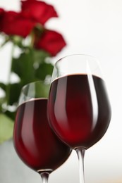 Photo of Glasses full of delicious red wine, closeup. Romantic date