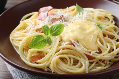 Delicious spaghetti with cheese sauce and meat on table, closeup