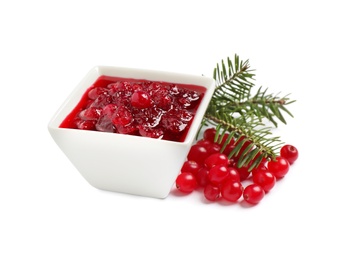 Cranberry sauce, fir tree twigs and fresh berries on white background