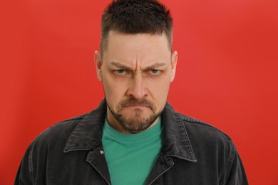 Angry man on red background. Hate concept