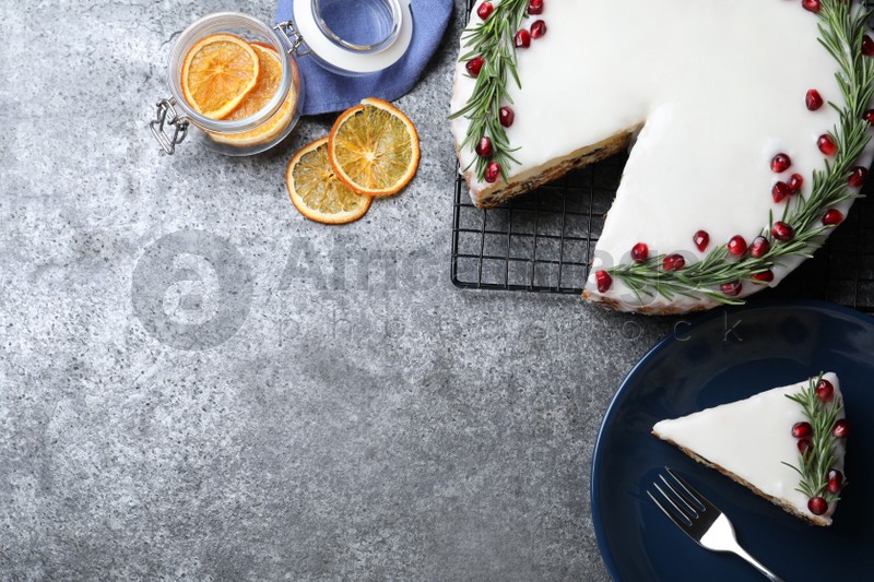 Photo of Flat lay composition with traditional Christmas cake on grey table. Space for text