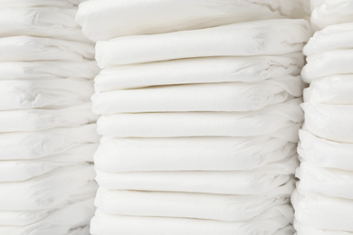 Stacks of baby diapers as background, closeup
