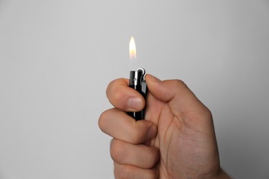 Man holding lighter on white background, closeup