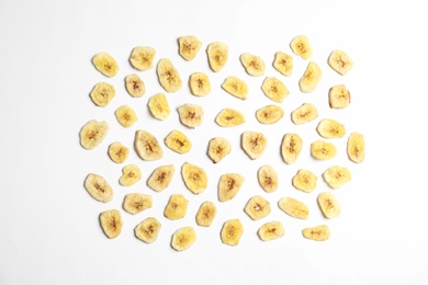 Flat lay composition with banana slices on  white background. Dried fruit as healthy snack