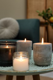 Photo of Lit candles on table in living room. Space for text