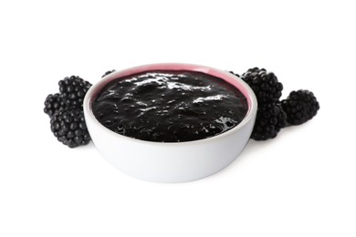 Photo of Blackberry puree in bowl and fresh berries on white background