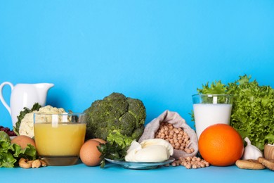 Food high in calcium. Different products on light blue background