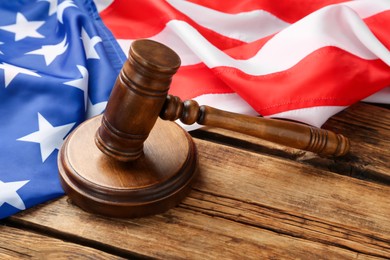 Photo of Wooden gavel and American flag on table