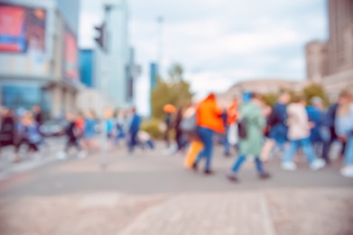 People walking on city street, blurred view