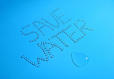 Photo of Inscription Save Water made of drops on light blue background