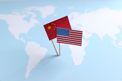 American and Chinese flags on world map. Trade war concept